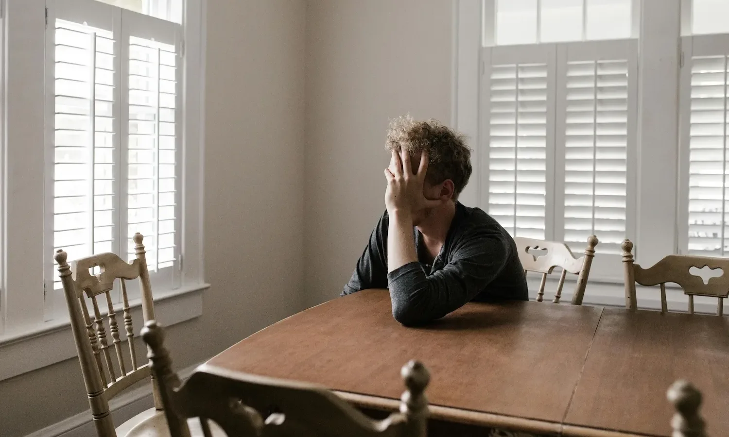 exhausted man at dining table